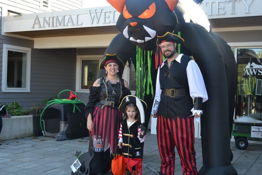 family in pirate costumes stand outside Animal Welfare Society's adoption center
