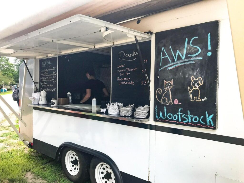 food truck with menus and notes written on blackboards during Woofstock Festival