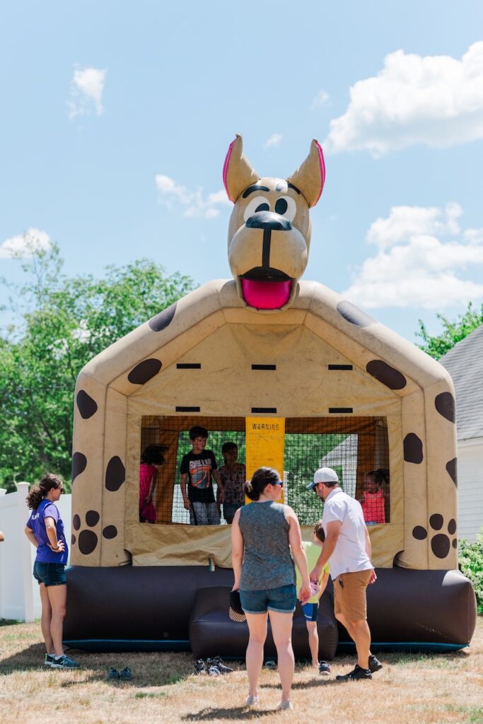 children jump in dog shaped bounce house during Woofstock Festival