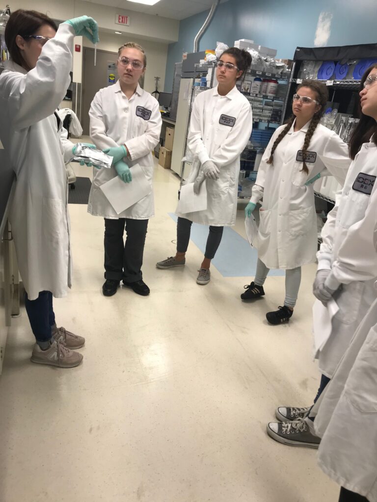 students in white lab coats during animal care intensive