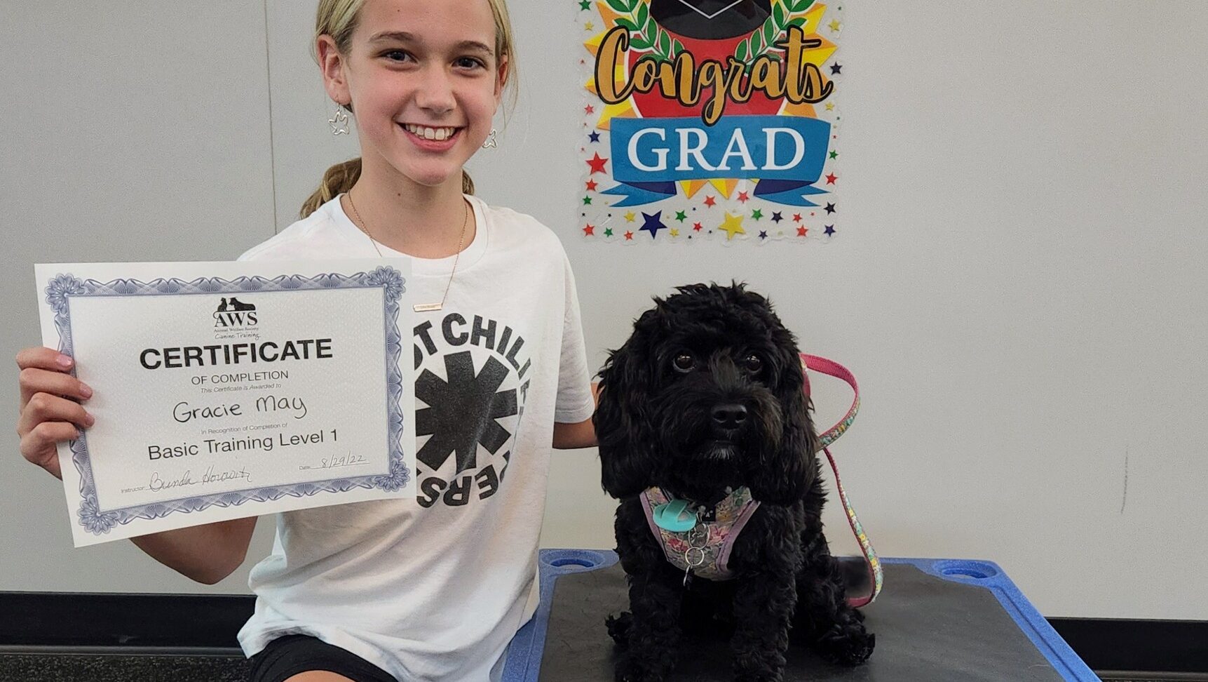 child and dog receive training certificate