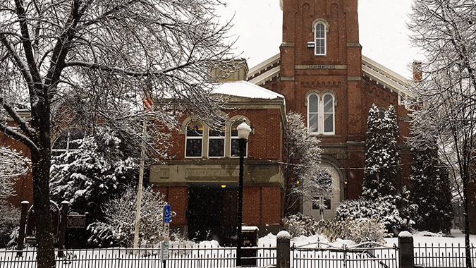 Far away shot of Biddeford McArthur Library in the snow.