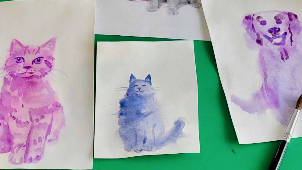 Close up of watercolor paintings of dogs and cats.