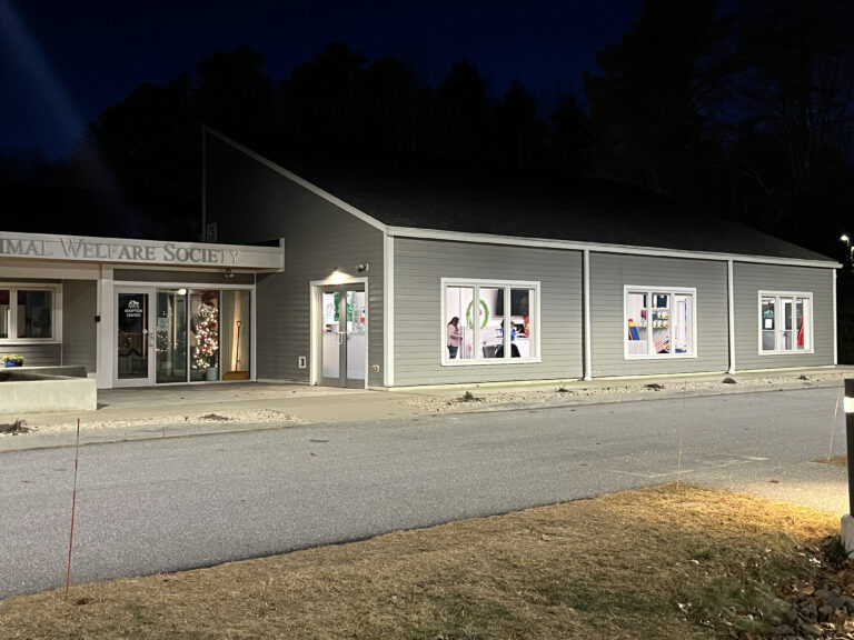gray building at night with holiday lights coming from within