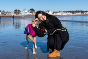 A photo from Hopper's Weekend Excursions, where he is snuggled up on the beach with his dog date.